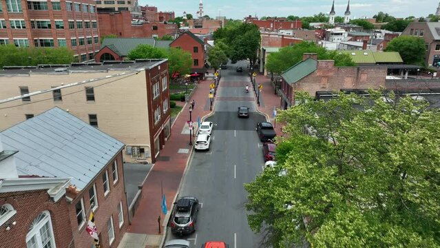 American flag and Maryland flag in downtown Frederick MD. Walkable historic downtown renovated and restored. Tourism in USA theme.