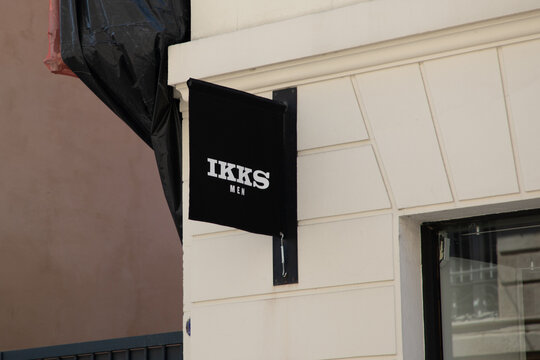 ikks men logo brand and text on shop facade wall sign in the main shopping street of the city