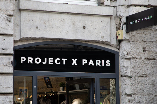 project x paris logo brand and text on streetwear shop facade wall sign in the main shopping street of the city