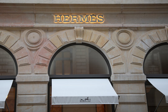Hermes logo brand and text sign chain on store building facade of French high fashion shop luxury goods manufacturer