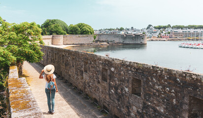 Woman tourist walking in Concarneau citadel- France