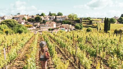 Woman in the vineyards in summer season- Saint Emilion near Bordeaux in France