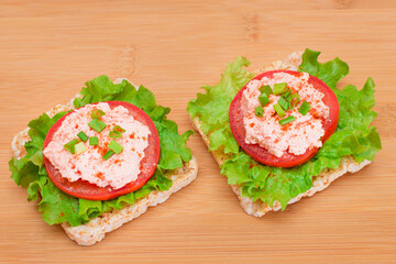 Rice Cake Sandwich with Tomato, Lettuce, Fish Cream and Green Onions on Bamboo Cutting Board. Easy Breakfast. Quick and Healthy Sandwiches. Crispbread with Tasty Filling. Healthy Dietary Snack