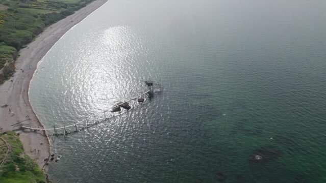 Impressive fishing platforms on stilts on the trabocchi coast of Abruzzo, Punta Aderci, Italy 4k drone