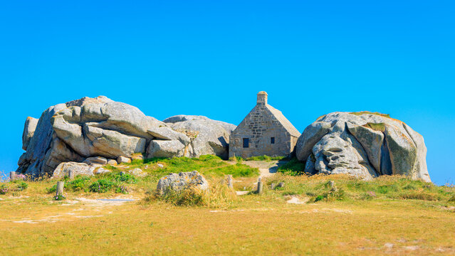 Brittany in France- House between granite rocks in Meneham village Kerlouan, Finistere