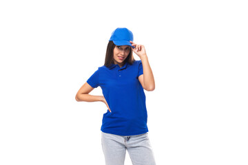 young brunette woman in a blue cap and t-shirt on a white background with copy space