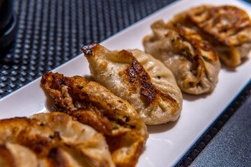 A plate of 6 fried momos with a stuffing of delicious chicken is kept on a plate. These famous momos are ready to serve the taste buds that create a delightful culinary experience.