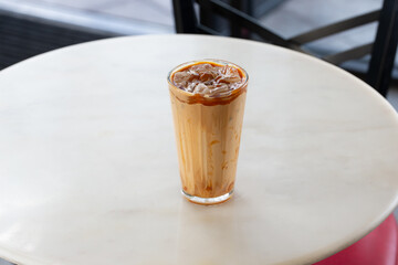 A view of an iced caramel macchiato beverage.