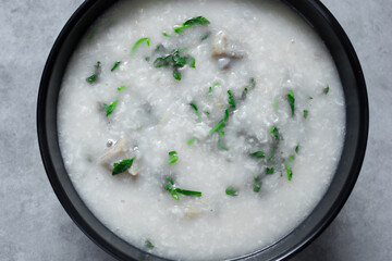 A top down view of a bowl of pork congee.