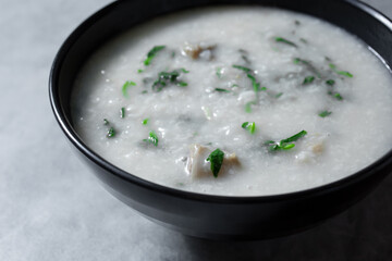 A view of a bowl of pork congee.
