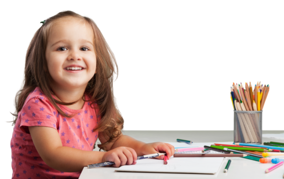 Cute little girl doing homework,writing and painting.