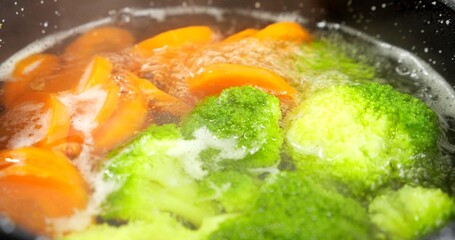 Close up Broccoli and carrot boiled in a water. Fresh vegetables cooked. Healthy food concept