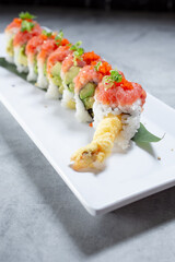 A view of a sushi roll featuring tempura shrimp, spicy tuna, and avocado.