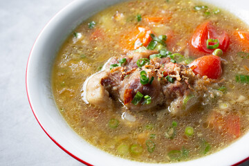 A closeup view of a bowl of sop buntut.