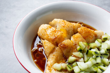 A closeup view of a bowl of pempek.