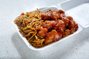 A view of a 1 item combo of Chinese fast food, featuring orange chicken, chow mein and fried rice.