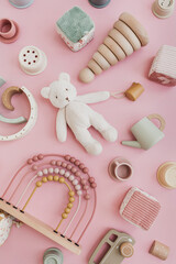 Set of stylish natural Scandinavian baby kids toys on pastel pink background. Baby girl stuff for...