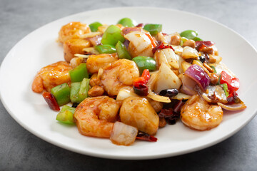 A view of a plate of kung pao shrimp and scallops.