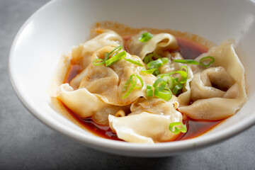 A view of a bowl of wontons.