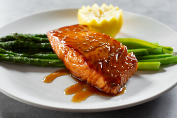 A view of a salmon steak with asparagus.