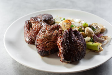 A view of a plate of filet mignon.
