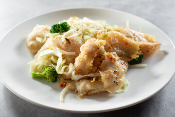 A view of a plate of lemon garlic fish.