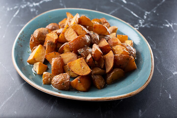 A view of a plate of roasted potatoes.