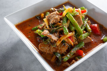 A closeup view of a bowl of pepper beef.