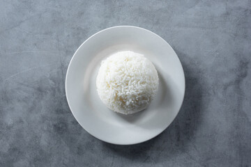 A top down view of a plate of steamed white rice.