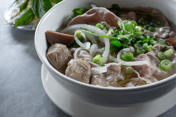 A view of a bowl of combo beef pho.