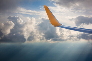 Naklejka na ściany i meble Wing of an airplane in the sunset