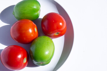 fresh tomatoes on a plate with white background