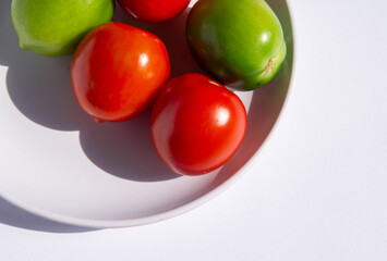 fresh tomatoes on a plate with white background