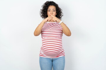 young pregnant woman wearing striped t-shirt over white background Has rejection angry expression...