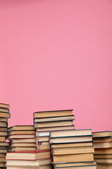 education science stack of books in the library on a pink background