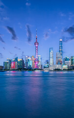 Obraz premium City buildings and beautiful clouds at night in Shanghai, China