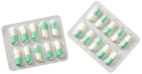 Green capsules in the plastic blister, isolated on white background, top view.