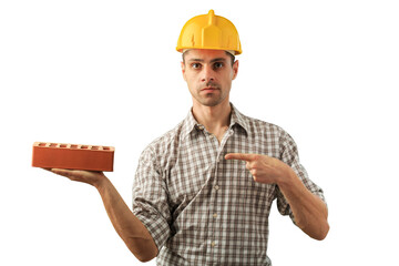 Handsome man in worker helmet with brick