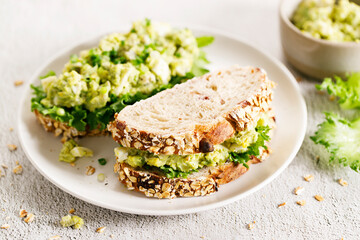 Healthy breakfast toast with avocado egg salad.