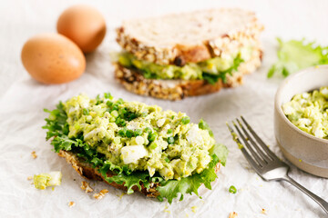 Healthy breakfast toast with avocado egg salad.