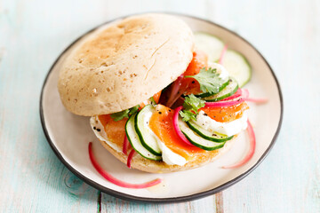 Smoked salmon sandwich with cucumber and cream cheese.