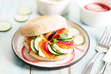 Smoked salmon sandwich with cucumber and cream cheese.