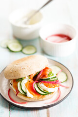 Smoked salmon sandwich with cucumber and cream cheese.