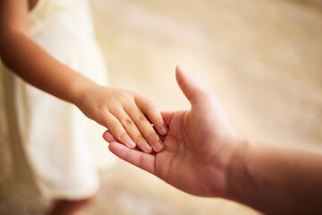 Love, closeup with person with their child and holding hands for support. Care with happy family, help or trust and parent hold her kids hand for compassion or calm with mockup space together