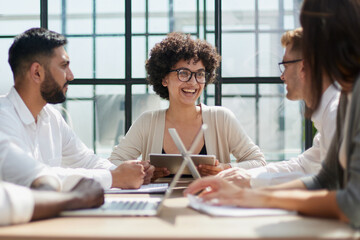 Fototapeta premium Employees working at computer together, discussing content