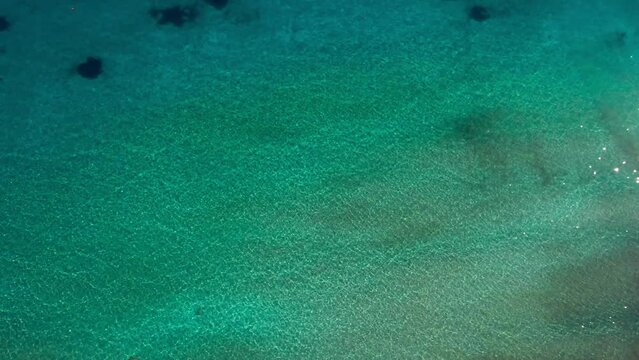 Sea green ocean water in sunshine outdoors on summer day. Drone view calm crystal clear Mediterranean sea on Cyprus outdoors
