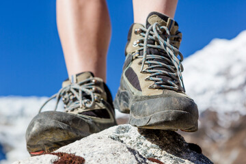 Hiking boots closeup on mountain rocks in Himalayas