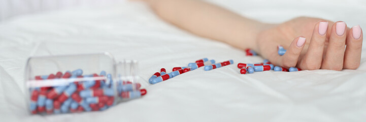 Overdose pills and drug addict background. Woman sleeps unconscious after eating pills on bed....