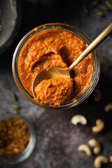 Homemade curry paste in a glass with a spoon