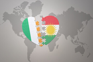 puzzle heart with the national flag of kurdistan and ireland on a world map background.Concept.